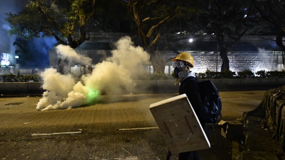 A protester holds a makeshift shields along a road outside the Tsim Sha Tsui police station on August 3. Photo via AFP.