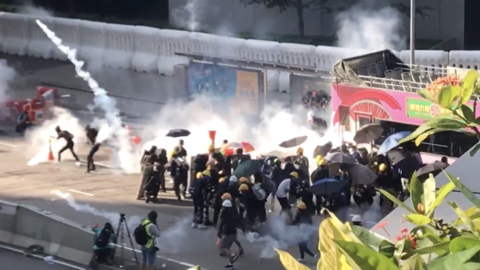 Protesters through tear gas rounds back at police in Admiralty on Monday afternoon. Screengrab via Cheryl Ho.