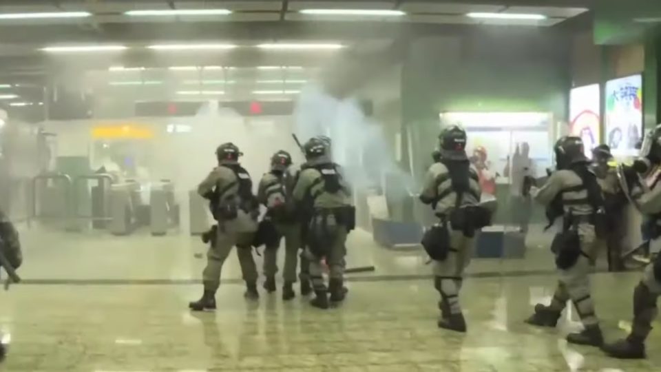 Riot cops fire tear gas into the paid concourse area of Kwai Fong MTR station on the night of August 11. Screengrab via YouTube.