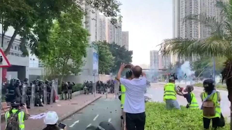 Police fire tear gas at a crowd of stone-throwing protesters outside the Tin Shui Wai police station this afternoon. Screengrab via RTHK video.