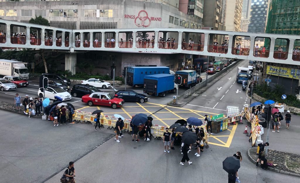 Protesters build barricades yesterday evening in Tsuen Wan, which would become the scene of violence later in the night. Photo by Iris To.