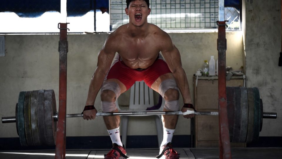 Weightlifter Sarat Sumpradit practices cleans in July during a training session at the national team’s training camp in the northern province of Chiang Mai. Photo: Lillian Suwanrumpha / AFP