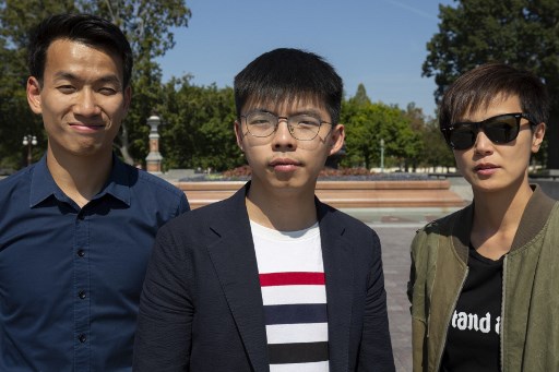Hong Kong pro-democracy activist Joshua Wong (C), Hong Kong Cantopop singer, actress and LGBT activist Denise Ho (R) and University of Washington student Brian Leung Kai-ping pose for a photo near the US Capitol in Washington, DC, on September 21, 2019. (Photo by Alastair Pike / AFP)