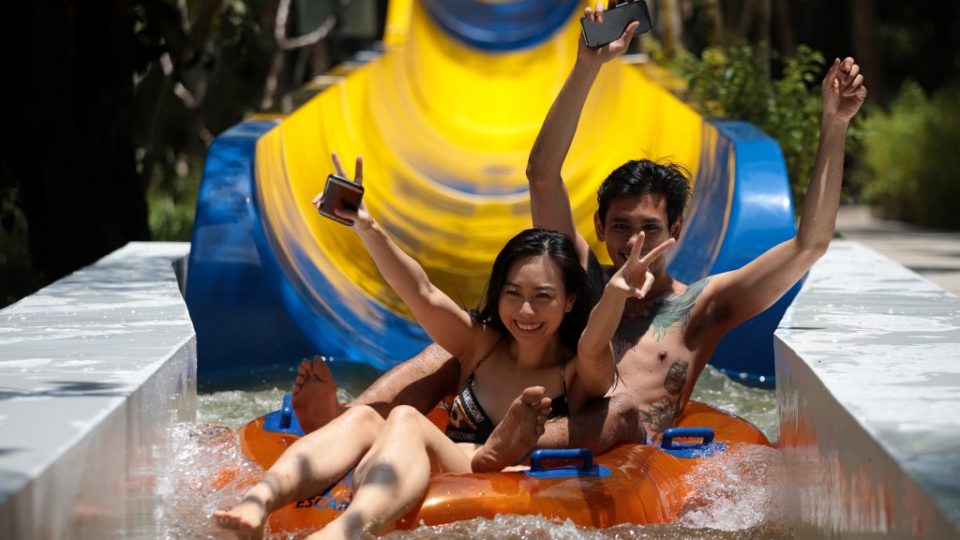 Theme park patrons enjoy the world’s longest water slide at Escape theme park in Teluk Bahang, Malaysia on September 25, 2019. – One of the world’s longest water slides was unveiled in Malaysia on September 25, a kilometre-long chute that starts from a hilltop before twisting and turning through dense jungle and splashing into a pool. (Photo by SADIQ ASYRAF / AFP)