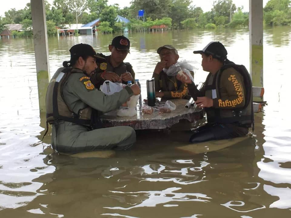 Bin, at far left, takes a lunch break with his rescue volunteer colleagues Saturday in Ubon Ratchathani. Photo:Bin Bunlueritr / Facebook