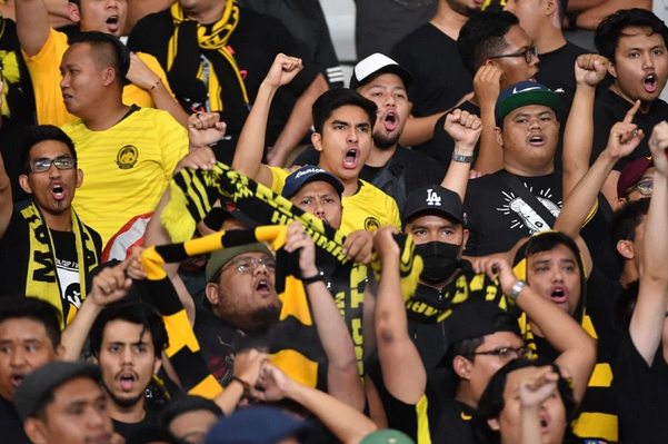 Minister Syed Saddiq and Harimau Malaysia fans via AFP