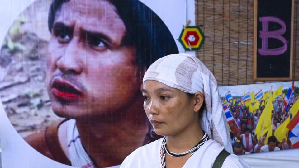 Pinnapha Phrueksapan, widow of ethnic Karen leader Por Cha Lee Rakcharoen — known as Billy, stands beside the portrait of her late husband following a ceremony in Bangkok on September 16, 2019. The wife of a murdered activist whose charred remains were found dumped in a Thai reservoir led an emotional memorial on September 16, saying their five young children had been left bereft by his death.
Photo: Joe Freeman / AFP