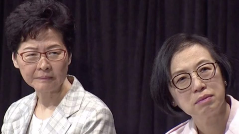 Chief Executive Carrie Lam and Health Secretary Sophia Chan listen to a question from a member of the public at a town hall meeting in Wan Chai on Thursday night. Screengrab via Facebook/Now News.