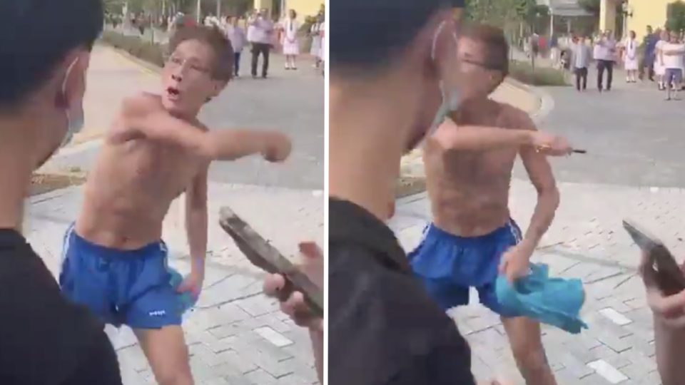 Video posted online shows a middle-aged man waving a razor at students taking part in a citywide boycott of classes. Screengrabs via Twitter/video.