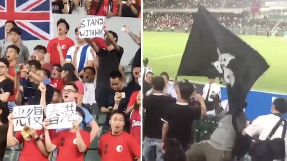 Fans boo and wave banners, flags and placards at a World Cup qualifying match between Hong Kong and Iran. Screengrab via Facebook/RTHK.