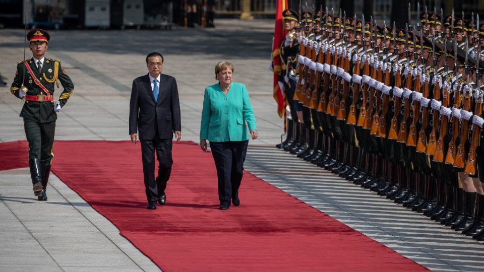 Chinese Premier Li Keqiang (center left) and German Chancellor Angela Merkel (center right) inspect an honor guard during a welcome ceremony at the Great Hall of the People in Beijing on September 6, 2019. Photo via AFP.
