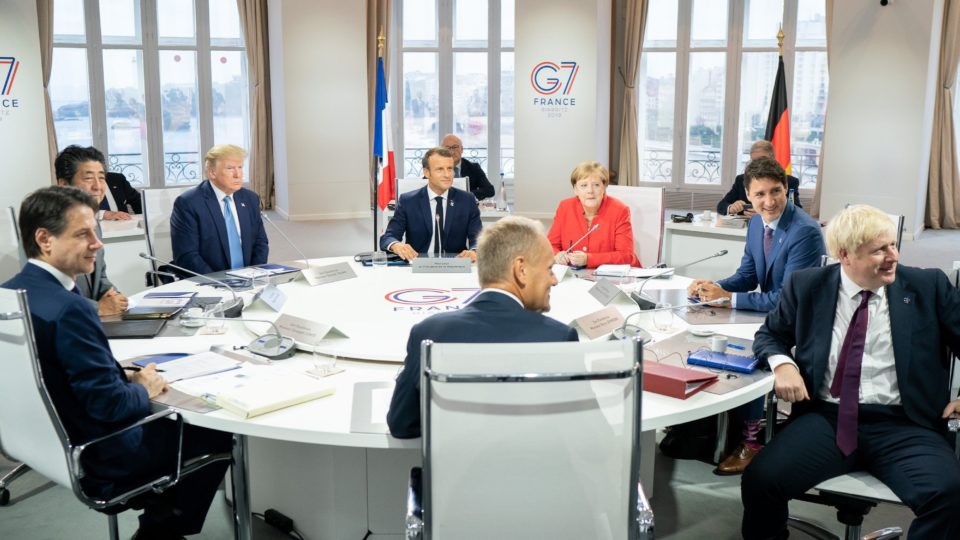 German Chancellor Angela Merkel (red jacket) appears with other world leaders at the recent G7 summit in France. Photo via the White House.