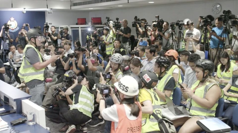 A representative from the Hong Kong Journalists’ Association reads out a statement criticising the police force of indiscriminately attacking journalists during last weekend’s protests. Screengrab via Facebook/Hong Kong Police.