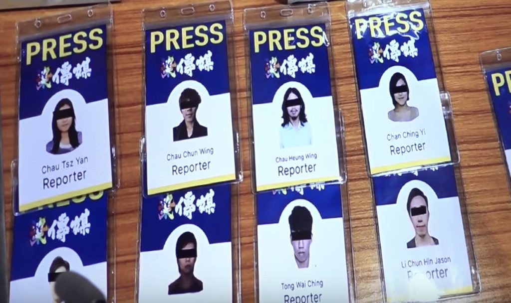 'Fake media passes' on display at a police press briefing on September 3. Screengrab via YouTube,
