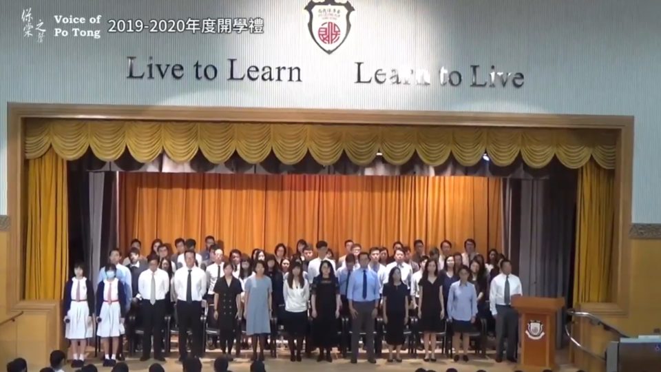 Stone-faced teachers stand awkwardly by as students drown out the Chinese national anthem with a rendition of ‘Do You Hear the People Sing’ at a school assembly on Monday. Screengrab via Twitter.