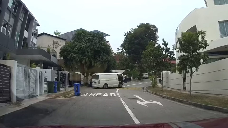 Screenshot of YouTube video showing van moving down a slop backward. 