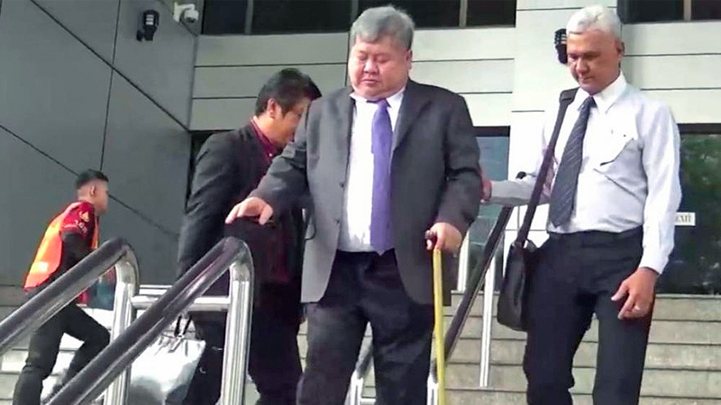 Premchai Karnasuta exits the criminal court Tuesday morning in Bangkok. Photo: Police News