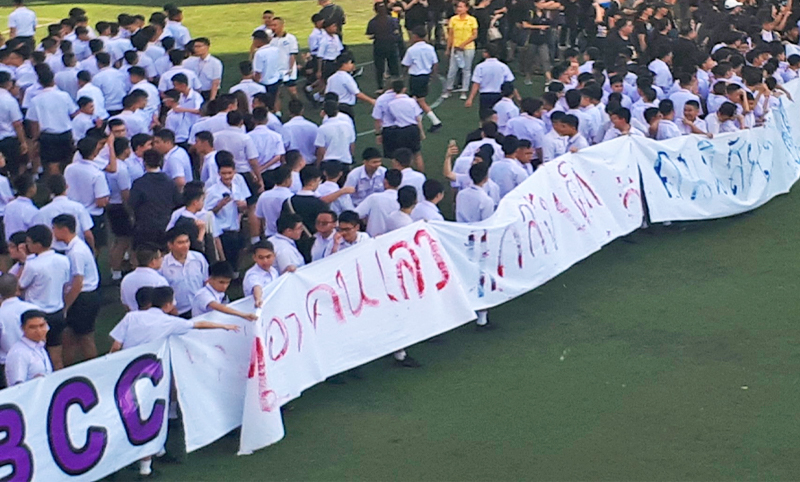 ‘We don’t want evil people in charge’ reads a banner held Monday by Bangkok Christian College students. Photo: @EdibleIodine / Twitter