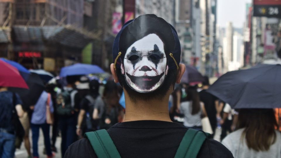 Protester wears a mask featuring Carrie Lam as The Joker at a protest on October 20, 2019. Photo by Vicky Wong.
