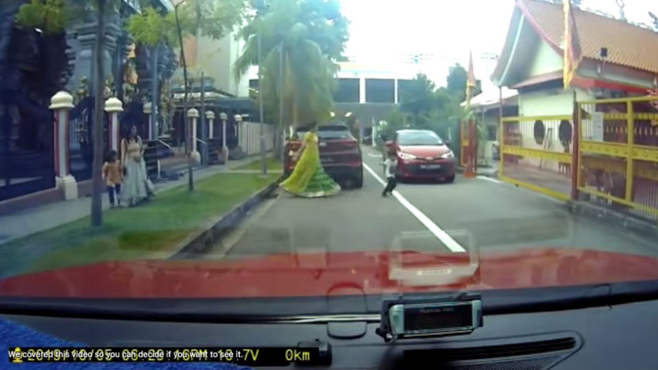 A woman chasing after a boy just before he got hit by a car on Depot Road. District Singapore/Facebook