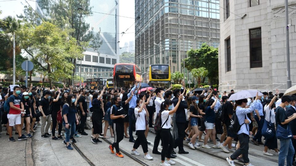 Protesters, many of them office workers, take part in an impromptu demonstration in Central today, one day after a teenage protester was shot by police during an unruly protest. Photo via AFP.