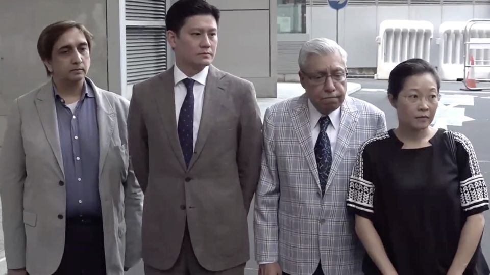 (From left to right) Philip Khan, Jeremy Tam, Mohan Chugani, and Phyllis Cheung arrive outside Police Headquarters in Wan Chai to file a formal complaint against the police use of a water cannon against the. The four were among a small group of people, mostly journalists, who were standing outside a mosque, and no other protesters were in the area. Screengrab via Apple Daily video.