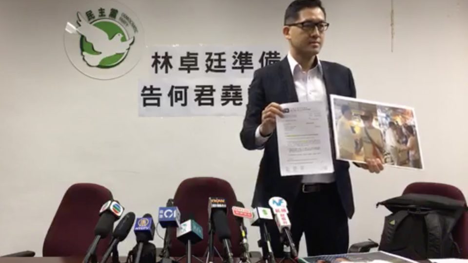 Lam Cheuk-ting holds up a copy of a legal letter confirming he’s suing pro-Beijing lawmker Junius Ho for defamation. Screengrab via Facebook video/Lam Cheuk-ting.