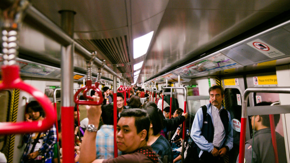 Commuters on an MTR train. Photo Illustration via Flickr/Mitch Altman.