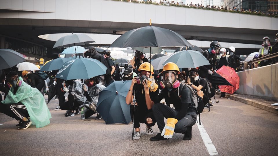 A young couple wait for the police response on Harcourt Road, shortly after water cannons were deployed in Admiralty. Photo by Samantha Mei Topp.