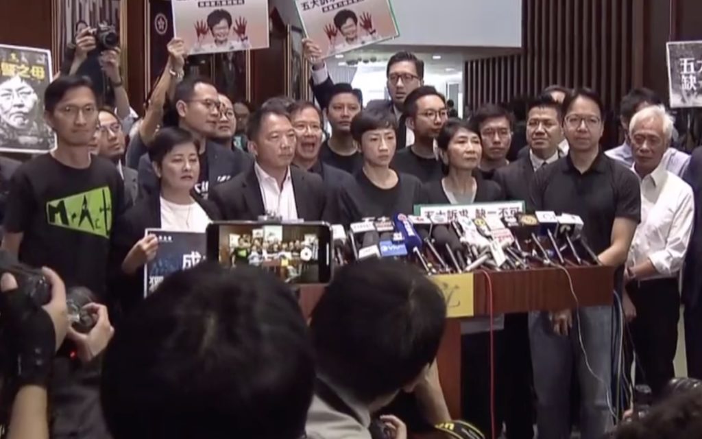 Pro-democracy lawmakers gather outside for a press briefing after Carrie Lam's 2019 policy address was adjourned. Screengrab via Facebook/Now TV.
