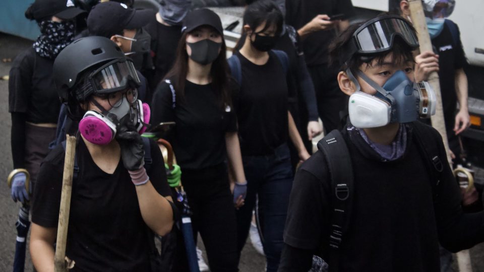 Masked protesters marching through Tai Kok Tsui in October. Photo by Vicky Wong.