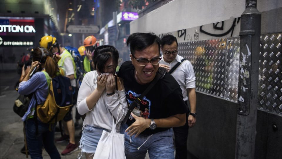 Bystanders react after police fired tear gas to disperse residents and protesters in the Mong Kok district of Kowloon in Hong Kong on October 27, 2019. Photo via AFP.