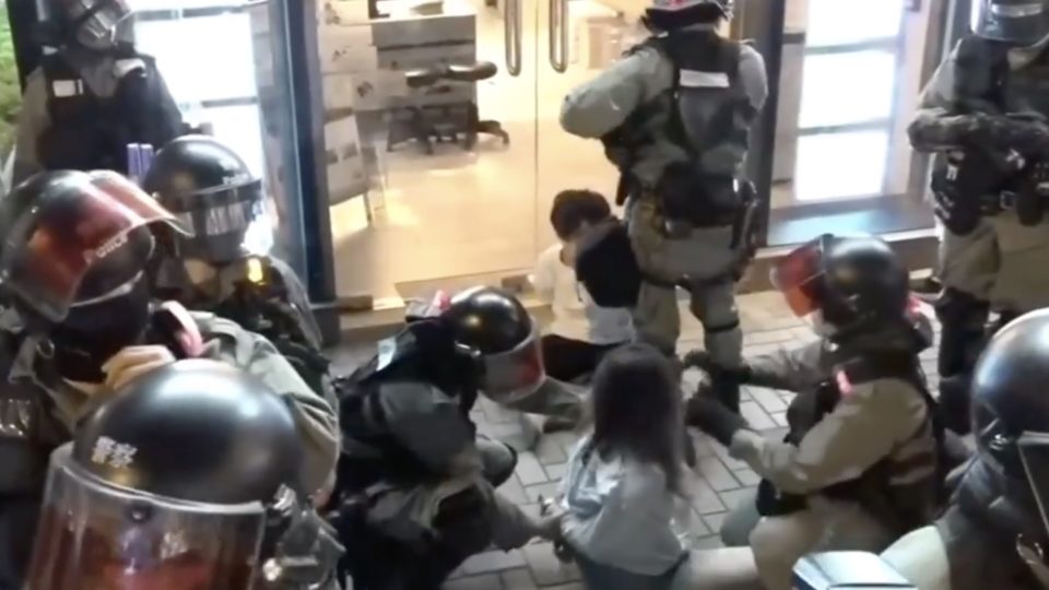 Police arrest two restaurant owners who refused to let police into the premises because they didn’t have a warrant. Screengrab via Facebook/i-Cable.