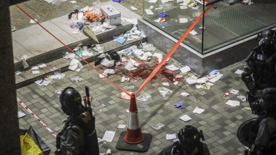 Blood and debris are seen on the ground at the entrance of a shopping mall after a bloody knife fight broke out in Hong Kong on November 3, 2019. – A bloody knife fight in Hong Kong left six people wounded on November 3 evening, including a local pro-democracy politician who had his ear bitten off, capping another chaotic day of political unrest in the city. (Photo by VIVEK PRAKASH / AFP)