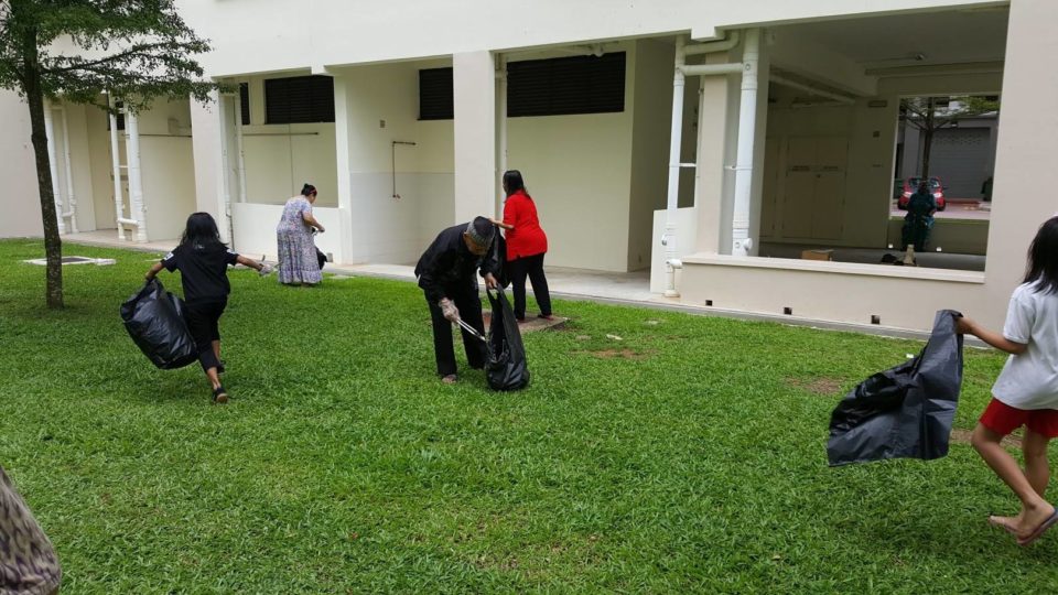 Singaporeans cleaning a public housing estate. Photo: Public Hygiene Council/Facebook