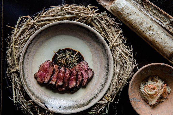 Charcoal-grilled local beef with red koji curry. Served with young bamboo shoot salad & sticky rice cooked in chicken stock. Photo: 80/20bkk / FB