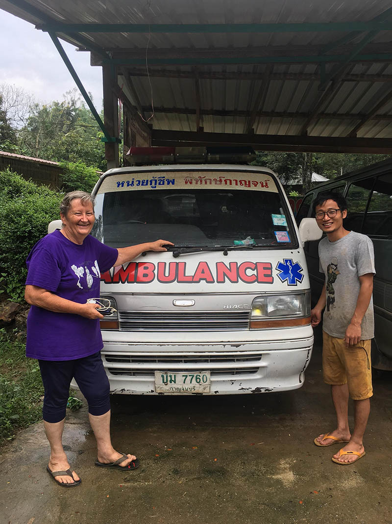 Catherine Riley-Bryan and Mowai Apisuttipanya stand proudly next to the Bamboo School's long-serving, first ambulance. Photo: Helen Mullen