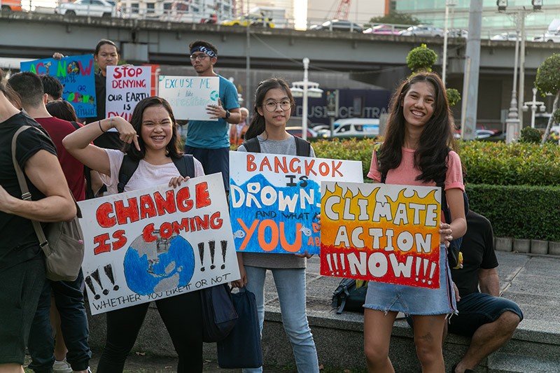 Climate Strike Thailand supporters join a “die-in” late Friday afternoon at Bangkok’s Lumphini Park. Photo: Joshua James