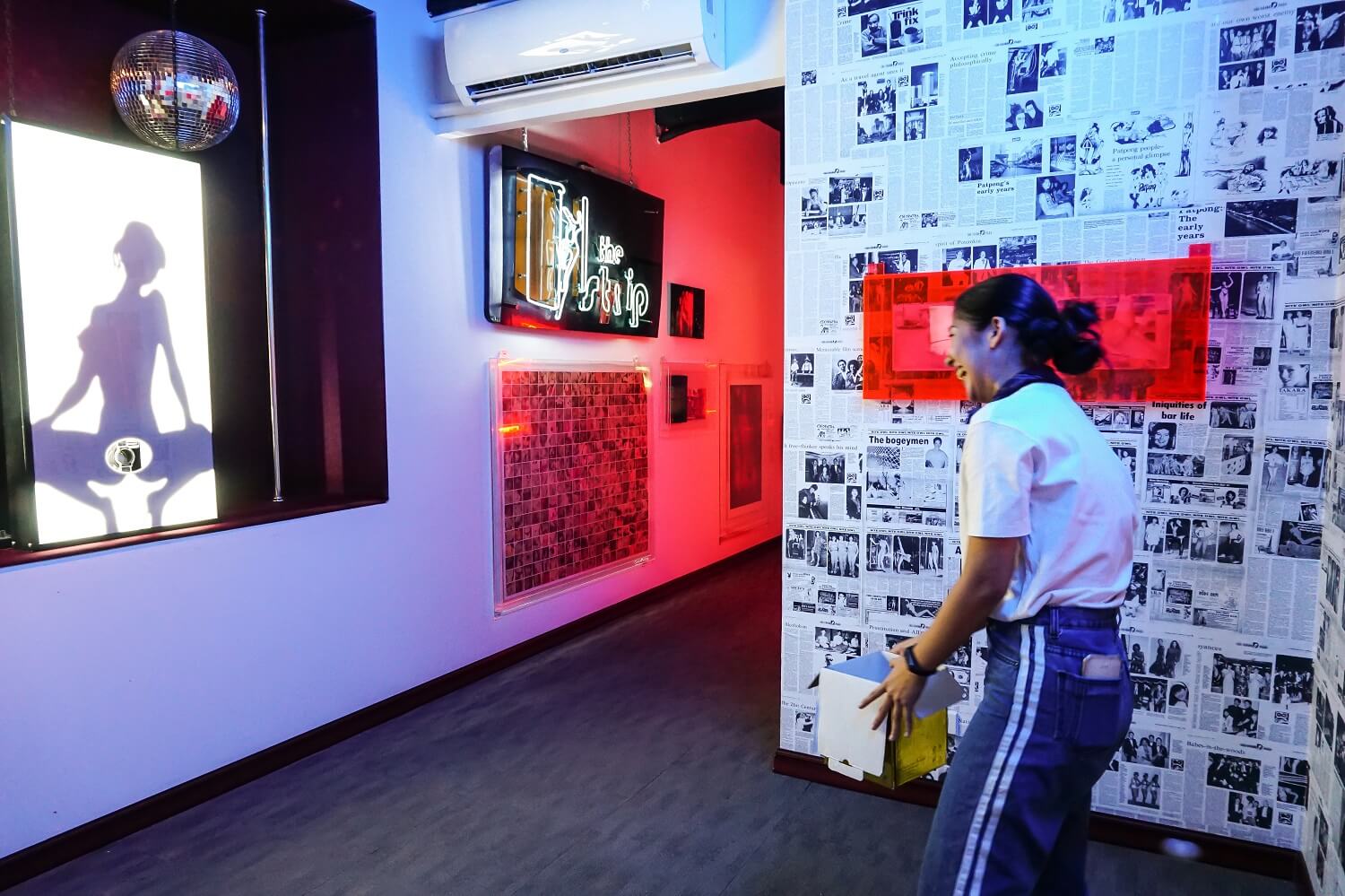 A visitor tries to catch ping-pong balls shot from a display. 