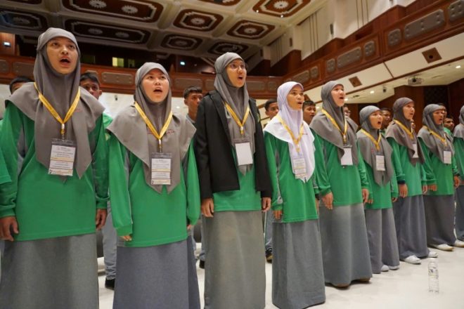 Students assembled in a university auditorium to practice ballads specially written for the pontiff. Photo: Joe Freeman / AFP