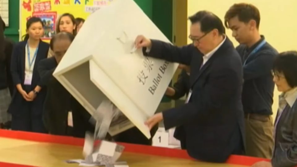 Election officials empty ballots onto a table as counting in Hong Kong’s district council elections gets underway last night. Screengrab via YouTube.