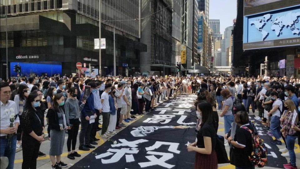 Hundreds have a moment of silence for 22-year-old Chow Tsz-lok, the student who died days after falling from a height at a car park in Tseung Kwan O. Photo by Vicky Wong.