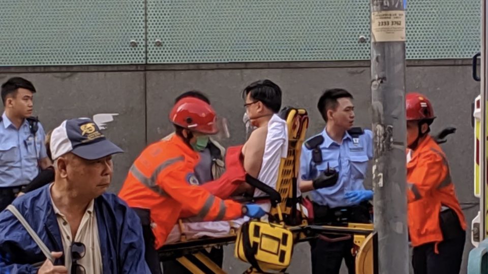 Pro-Beijing lawmaker Junius Ho being taken away in an ambulance after being stabbed while canvassing in Tuen Mun. Photos via Twitter/Galileo Cheng.