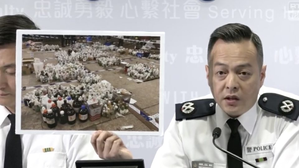 Assistant commissioner of police operations, Chow Yat-ming holds up a photo of molotov cocktails seized from the Hong Kong Polytechnic University. Screengrab via Facebook.