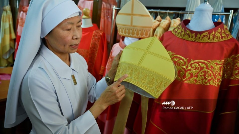 Sister Saengpradab holds embroidered headwear beside the silk robe, at right, for Pope Francis on Monday at the Praharuthai Convent in Bangkok. Photo: Romeo GACAD / AFP