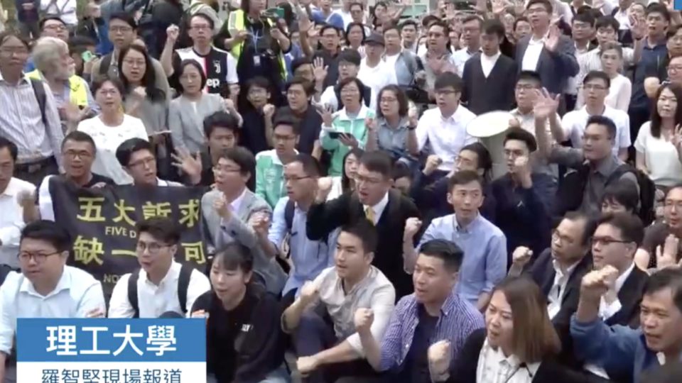 Newly-elected pro-democracy district councillors gathered in Tsim Sha Tsui to rally for support for those still trapped inside Polytechnic University, Screengrab via Apple Daily video.