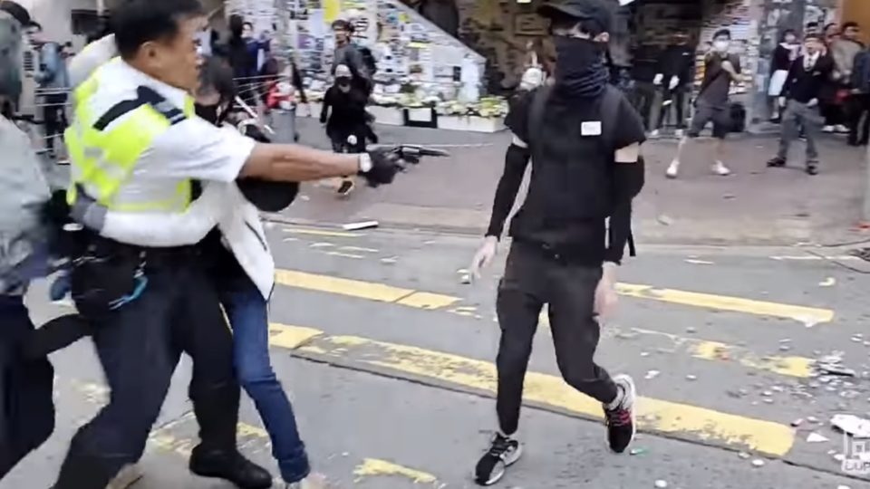 The moment a police officer shot a 21-year-old protester in the abdomen. Screengrab via YouTube.