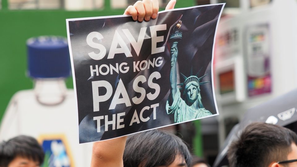 A protester holds up a sign calling on the U.S. to pass the Hong Kong Human Rights and Democracy Act during a rally in September. Photo via Flickr/Etan Liam.