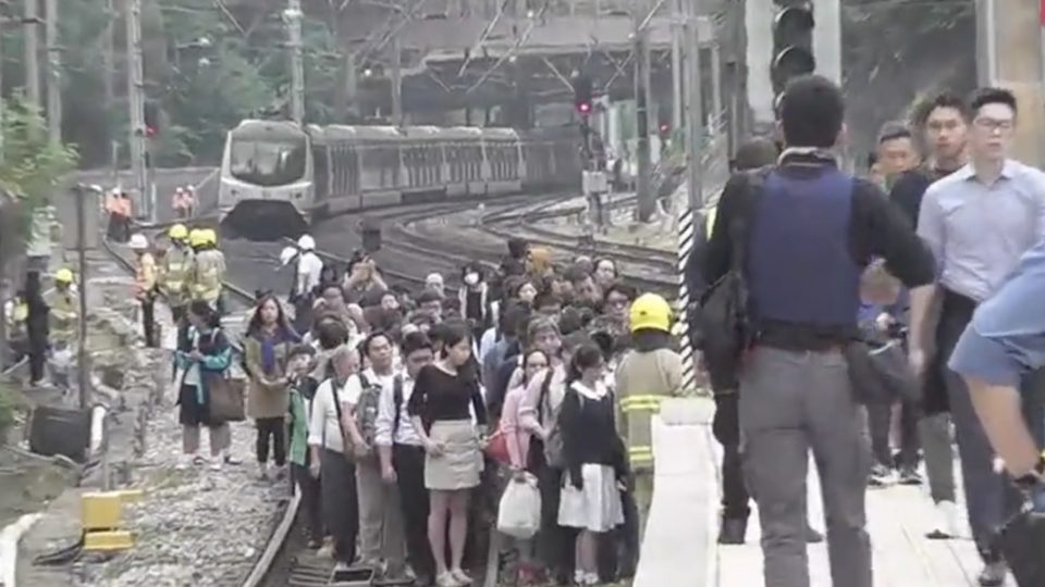 Passengers on board an East Rail Line train had to walk to Sha Tin station after protesters had thrown debris onto the tracks. Screengrab via Facebook video/HK01.