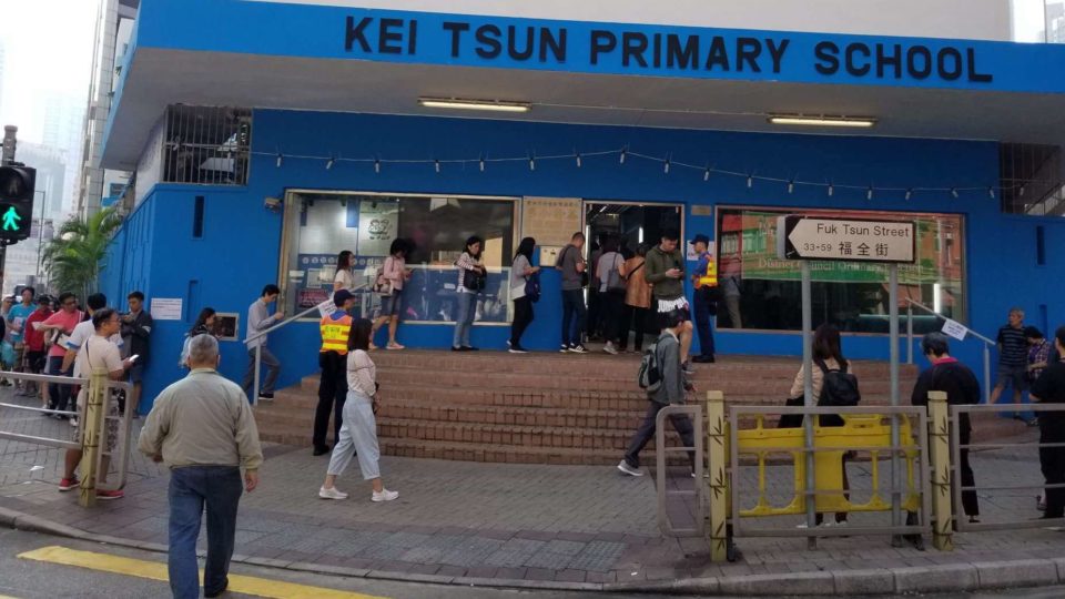 A line of voters trails out of a polling station in Tai Kok Tsui today. Photo by Vicky Wong.